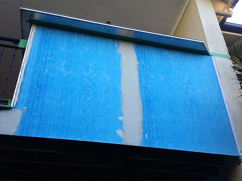 Blue boards on house before getting rendered